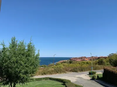 an empty road with the ocean in the background at View Apartments in Sozopol