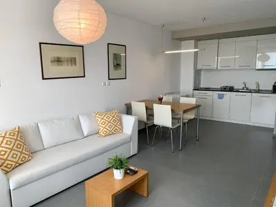 a living room and kitchen with a couch and a table at View Apartments in Sozopol