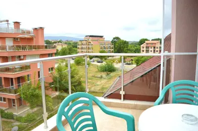 a balcony with two chairs and a view of a city at Hotel Paradise in Lozenets