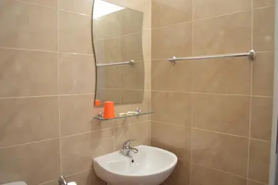 a bathroom with a sink and a mirror at Hotel Paradise in Lozenets