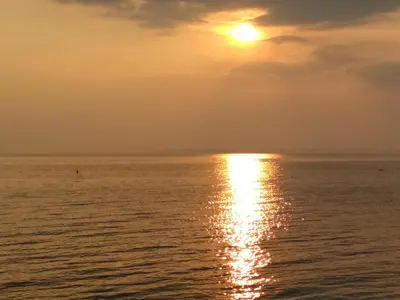 an image of the sun setting over the ocean at Виктория in Pomorie