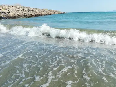 a group of small waves in the ocean at DEA Pasavan Apartments in Ravda