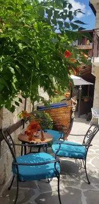 a patio with two chairs and a table and chairs at Kirios Hotel in Nesebar
