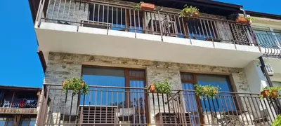 a building with balconies and potted plants on it at Kirios Hotel in Nesebar