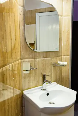 a bathroom with a sink and a mirror at Kirios Hotel in Nesebar