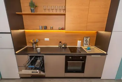 a small kitchen with a sink and a stove at Pomorie Seaside Apartments in Pomorie