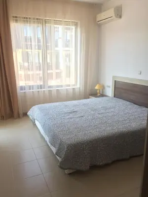 a bedroom with a bed and a large window at Apartment on the sea at St Nikolas Complex-Elena in Chernomorets