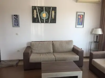 a living room with a couch and a coffee table at Apartment on the sea at St Nikolas Complex-Elena in Chernomorets