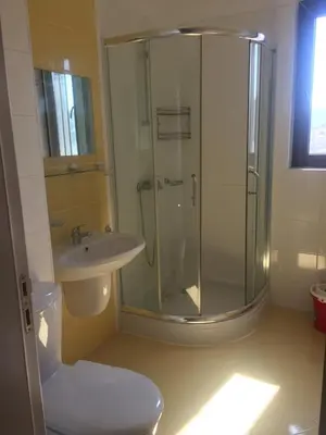 a bathroom with a shower and a toilet and a sink at Apartment on the sea at St Nikolas Complex-Elena in Chernomorets