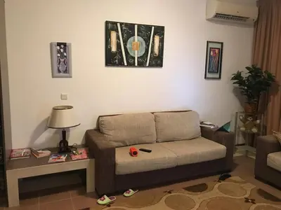 a living room with a couch and a table at Apartment on the sea at St Nikolas Complex-Elena in Chernomorets