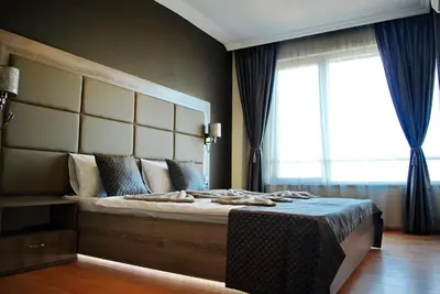 a bedroom with a large bed with a large window at Dune Boutique Pomorie in Pomorie