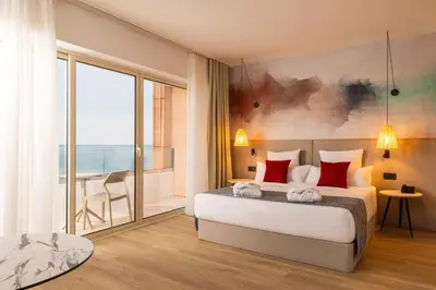 a bedroom with a large bed and a balcony at AluaSoul Sunny Beach - Adults Only - All Inclusive in Sunny Beach