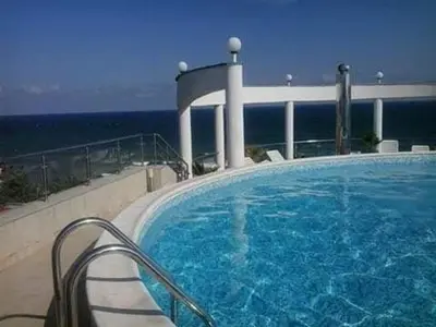 a large swimming pool with the ocean in the background at Vista Del Mar Ap 22 in Ravda