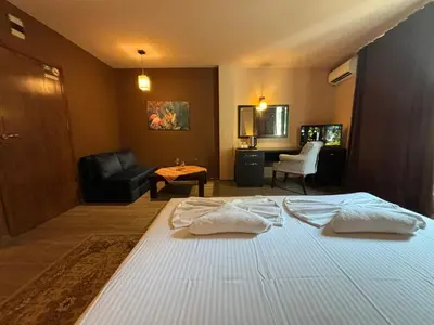a bedroom with a bed with two pillows on it at Family Hotel Vaso in Varna City