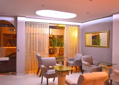 a living room with chairs and a table at Family Hotel Vaso in Varna City