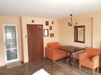 a living room with a table and two chairs at Family Hotel Vaso in Varna City
