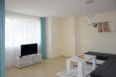 a living room with a couch and a tv at Rusalka Apart-Residence in Obzor