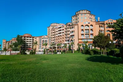 a large building with a grass field in front of it at Royal Park Hotel - All Inclusive in Elenite