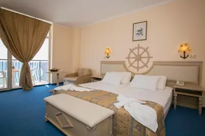 a hotel room with a bed and a large window at Royal Park Hotel - All Inclusive in Elenite