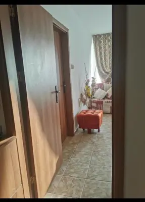 an open door to a living room with a red stool at Apartment Blue Komfort in Sunny Beach