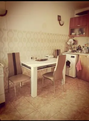 a kitchen with a white table and two chairs at Apartment Blue Komfort in Sunny Beach