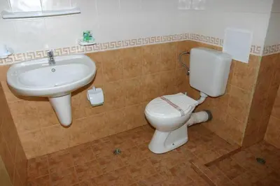 a bathroom with a toilet and a sink at Harmony Beach Family Hotel in Nesebar