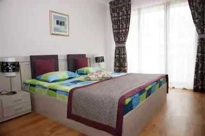 a bedroom with a large bed in a room at Long Beach Resort in Shkorpilovtsi