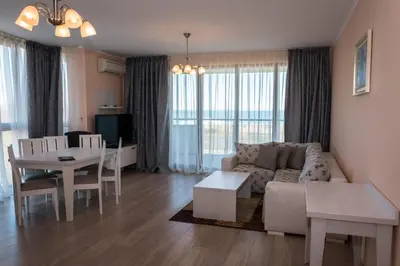 a living room with a couch and a table at Long Beach Resort in Shkorpilovtsi