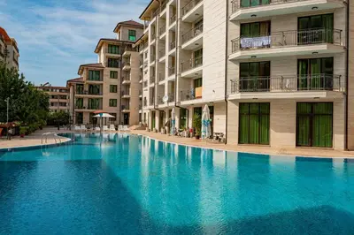 a large blue swimming pool in front of a building at Amadeus Lux - Menada Apartments in Sunny Beach