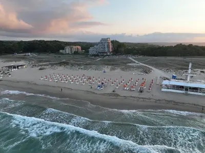 an aerial view of a beach with chairs and umbrellas at Allure Beach Resort Aparthotel in Primorsko