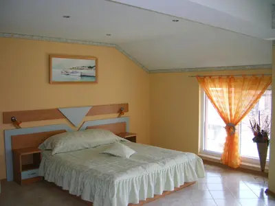 a bedroom with a bed and a window at Dari Guest Rooms Стаи за гости Дари in Nesebar