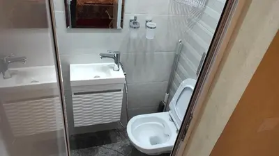 a small bathroom with a toilet and a sink at Burgas Central-Sheynovo in Burgas City