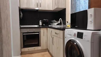 a kitchen with a washing machine and a washer at Burgas Central-Sheynovo in Burgas City