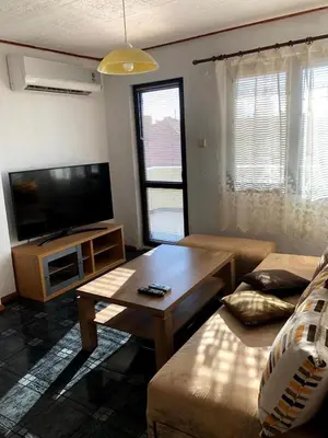 a living room with a couch and a table at Mariana Guest House Къща за гости Марияна in Pomorie