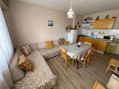 a living room with a couch and a table at Mariana Guest House Къща за гости Марияна in Pomorie