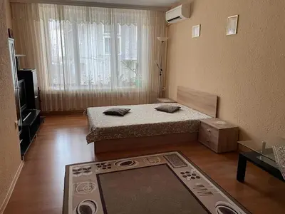a small room with a bed and a window at Mariana Guest House Къща за гости Марияна in Pomorie
