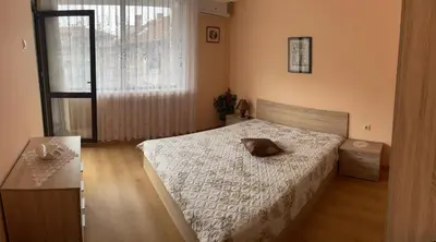 a bedroom with a bed with a pillow on it at Mariana Guest House Къща за гости Марияна in Pomorie