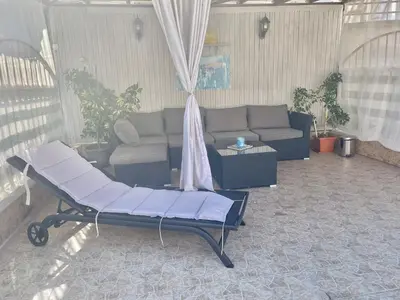 a living room with a couch and a table at White Rose Guest Rooms in Burgas City