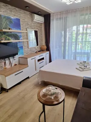 a bedroom with a bed and a tv and a table at Alex Studio, Sozopol, Kavaci in Sozopol