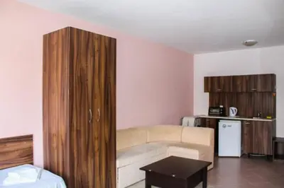 a living room with a couch and a kitchen at Family apartment 