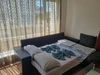 a couch with pillows on it in front of a window at Family apartment 