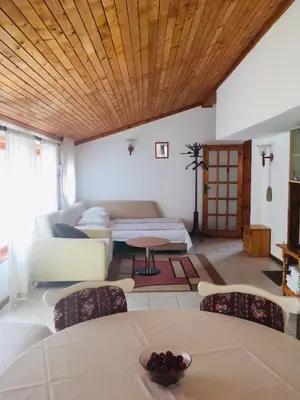 a living room with a couch and a bed at Guest House Barbov in Obzor