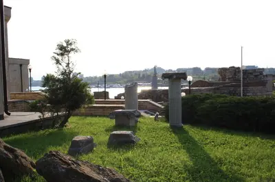 a garden with some rocks in the grass at Rony Hotel in Nesebar