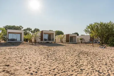 a row of houses on a sandy beach at Camping Gradina in Sozopol
