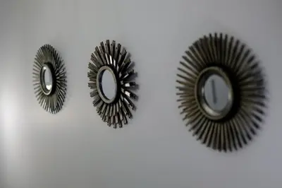 a pair of circular mirrors on a white wall at The Olive Green House - City Center - Free Parking in Burgas City