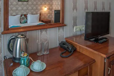 a room with a desk with a phone and a television at Mercury Hotel- All Inclusive in Sunny Beach