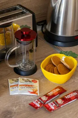 a food processor and a bowl of cookies on a counter at The Captain Be my guests! by RV Apartments in Varna City