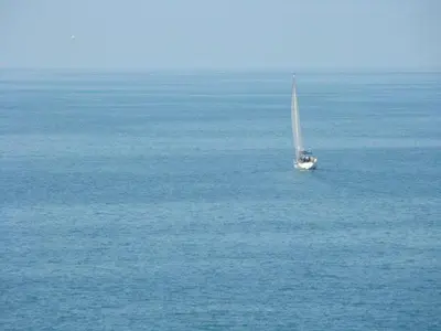 a sailboat in the middle of a large body of water at Deep Blue Guest House in Sozopol