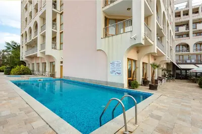 a swimming pool in front of a building at Viand Hotel - All Inclusive in Sunny Beach