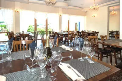 a dining room with tables and chairs with wine glasses at Viand Hotel - All Inclusive in Sunny Beach